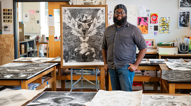 Zaire Miles-Moultrie posing next to one of his art pieces